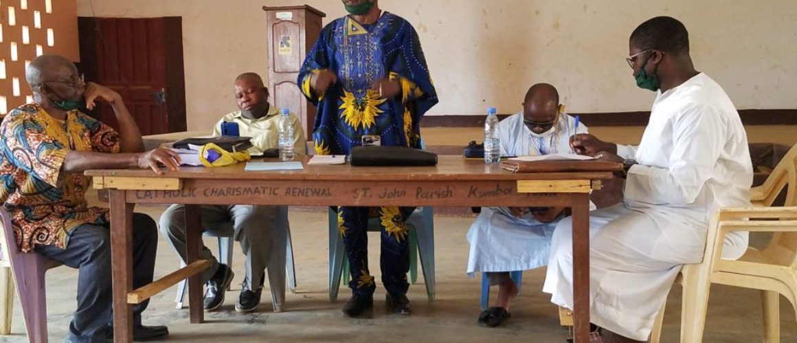 Image shows Chief Asuh standing and talking to the people